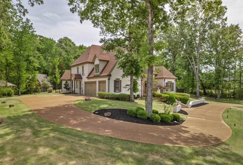 Triple garage and expansive circular drive provide abundant parking, all set within beautifully landscaped grounds that enhance both function and curb appeal.