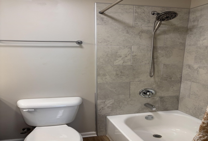 Tile to ceiling with a rain shower head.