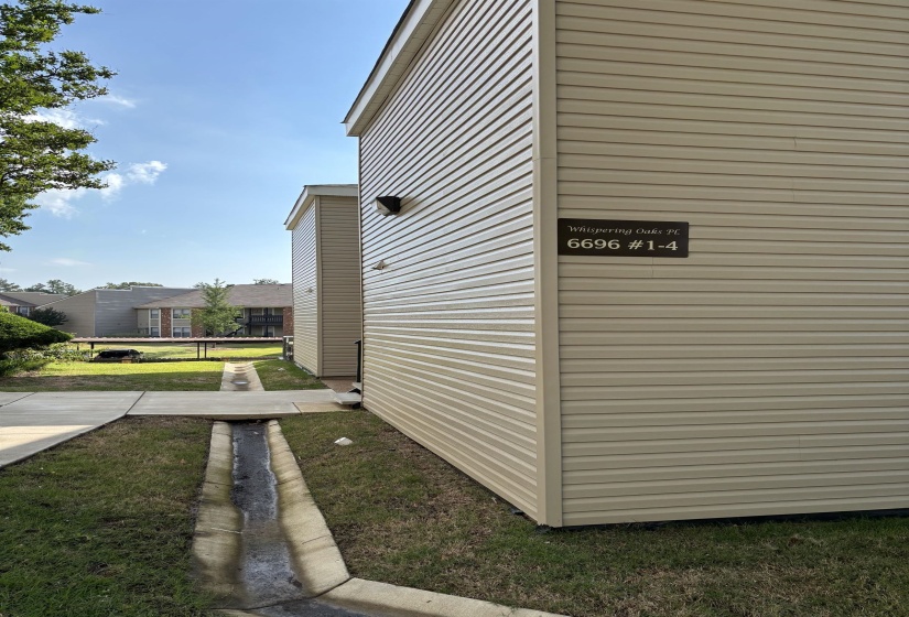 Walk to the left of the building to the entrance of the downstairs Units 1 and 3. Unit 3 is on the left. there's a KAIZEN sign in the window.