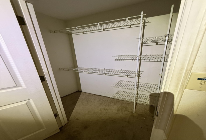 Closet featuring white wire shelving units and a light-toned door
