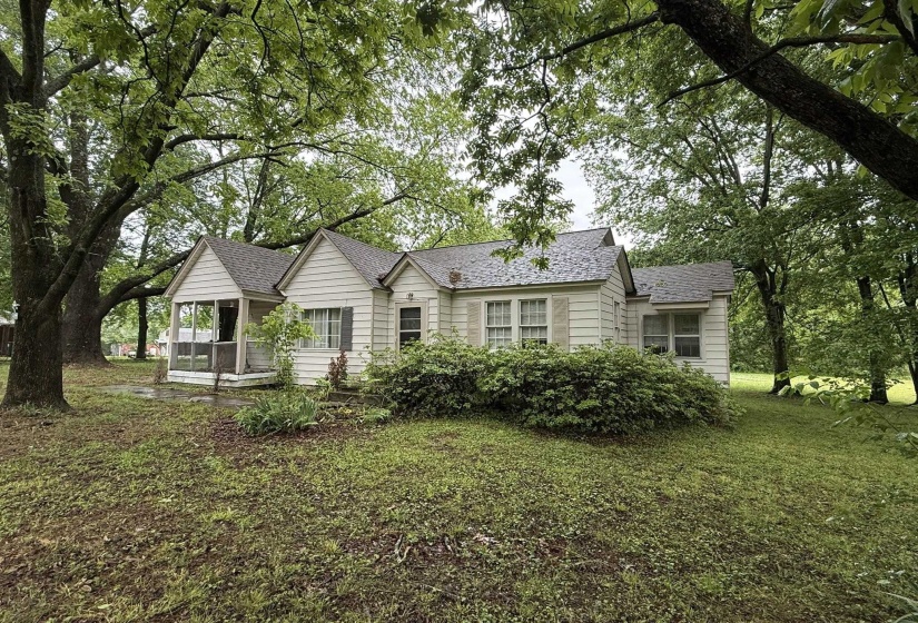 Single-story residence featuring light-colored siding and a dark-toned roof