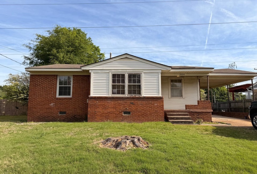 Brick and siding exterior featuring a covered front entry