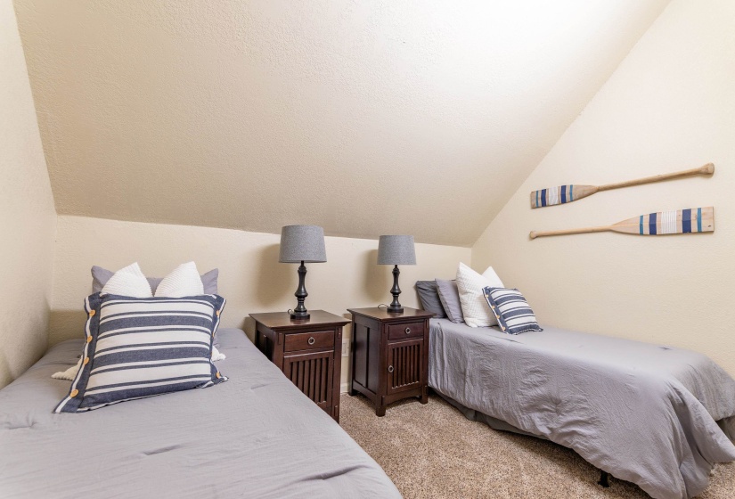 Attic room featuring sloped ceilings and light-toned walls