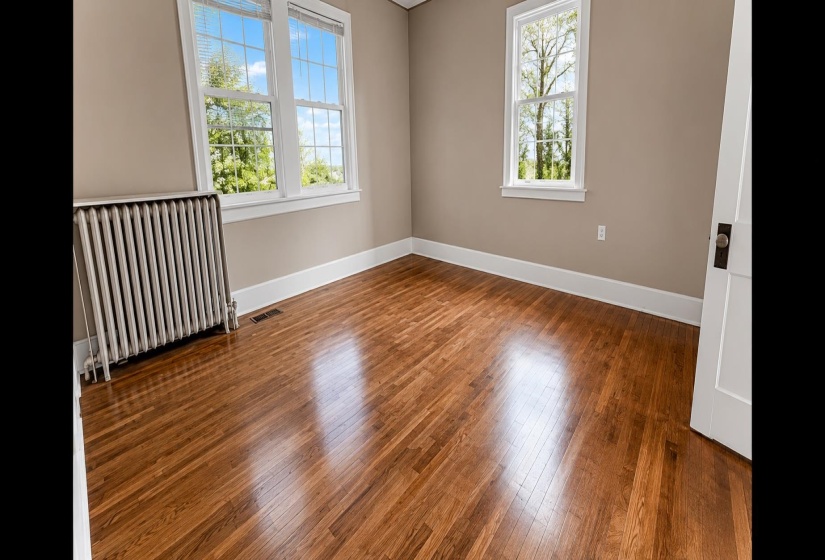 Refinished wood-finish flooring complements neutral wall tones