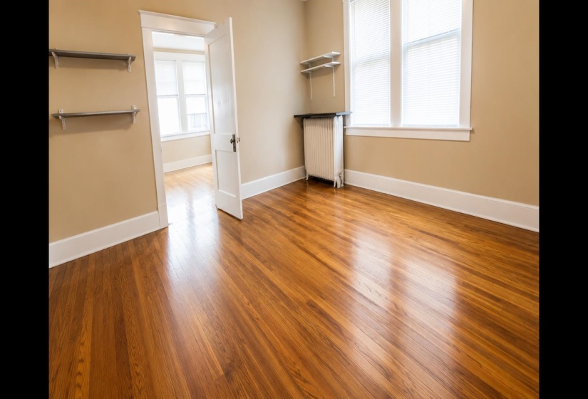 Hardwood flooring extends throughout this room, complemented by neutral wall tones