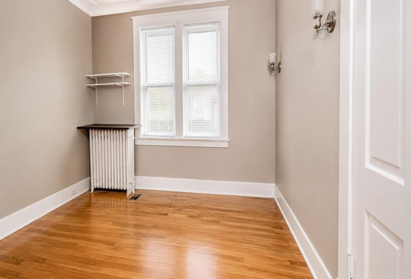 Hardwood flooring complemented by white trim and neutral wall tones