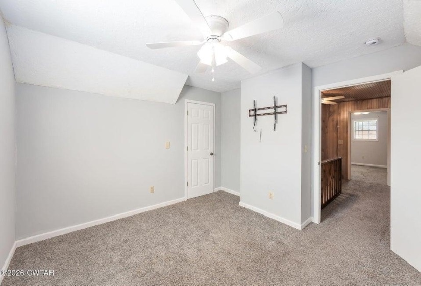 Bonus room featuring carpet and ceiling fan