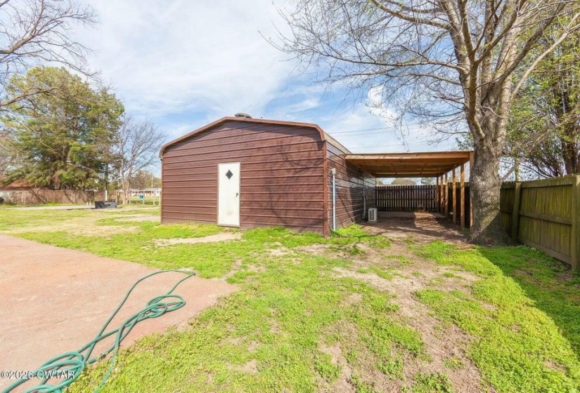 View of outdoor structure with a carport