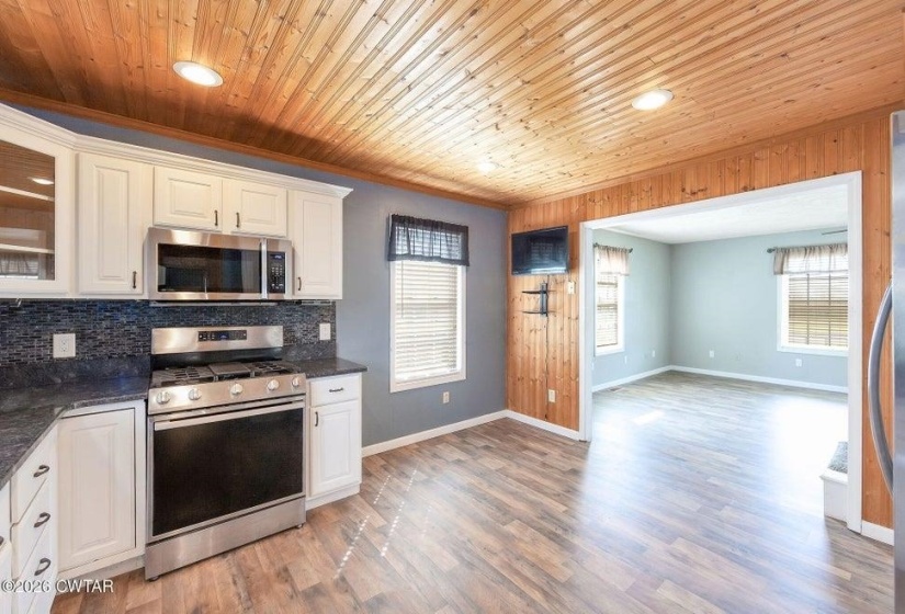Kitchen featuring stainless steel appliances, backsplash, plenty of natural light, light wood-type flooring, and recessed lighting