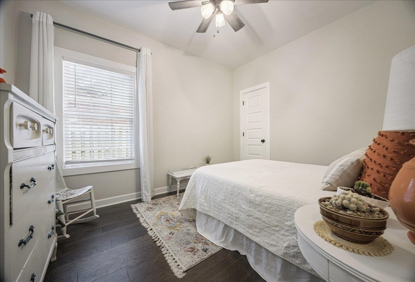 Bedroom featuring dark wood-type flooring and a ceiling fan
