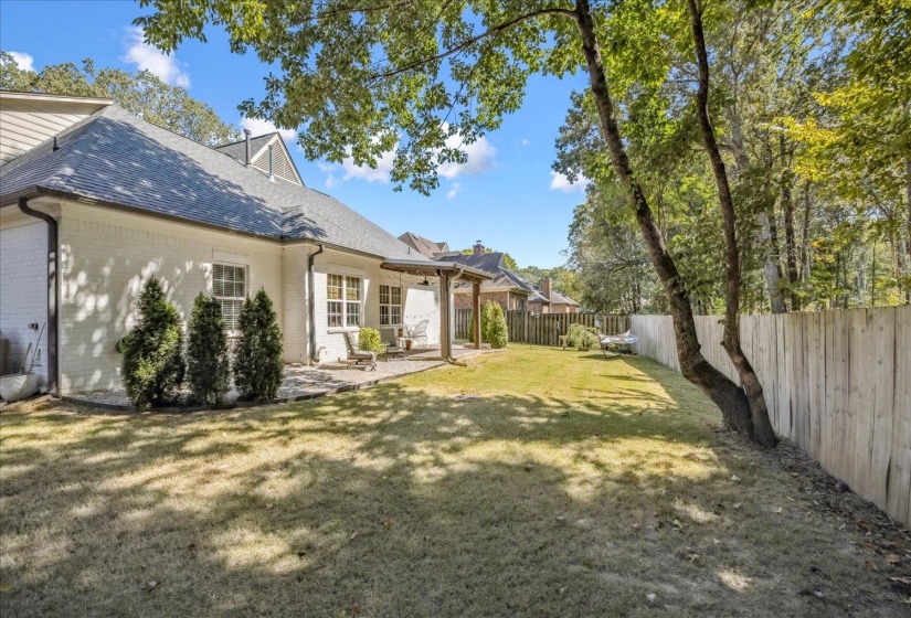 Fenced backyard with a patio and a pergola