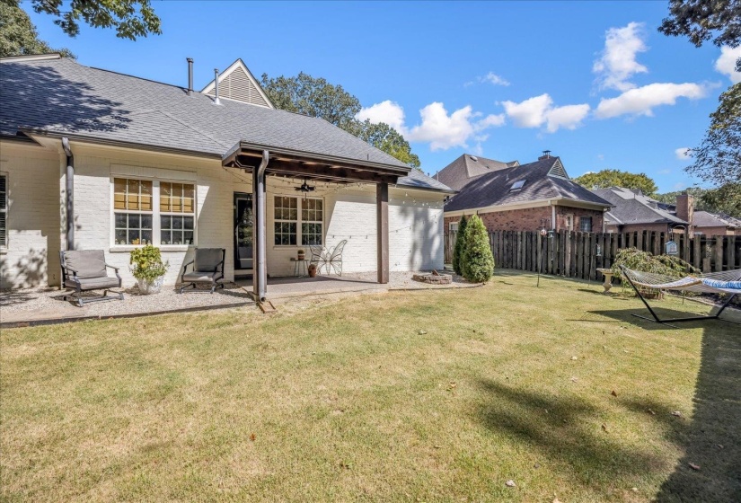 Back of house featuring ceiling fan, a patio area, brick siding, and roof with shingles