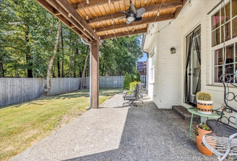 Fenced backyard featuring a ceiling fan and a patio