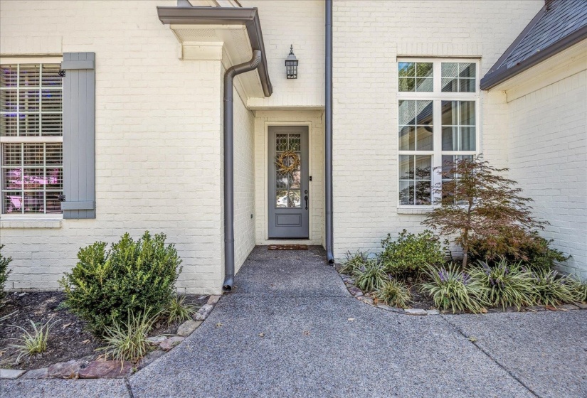 Property entrance featuring brick siding