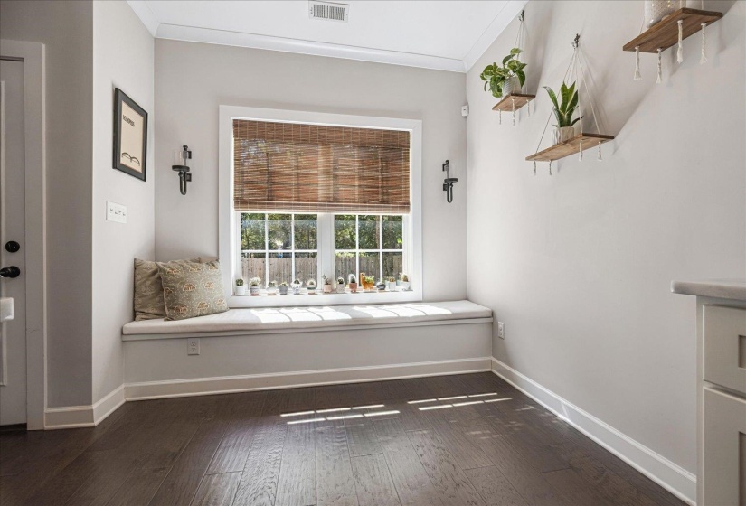 Unfurnished room featuring dark wood-style flooring and ornamental molding