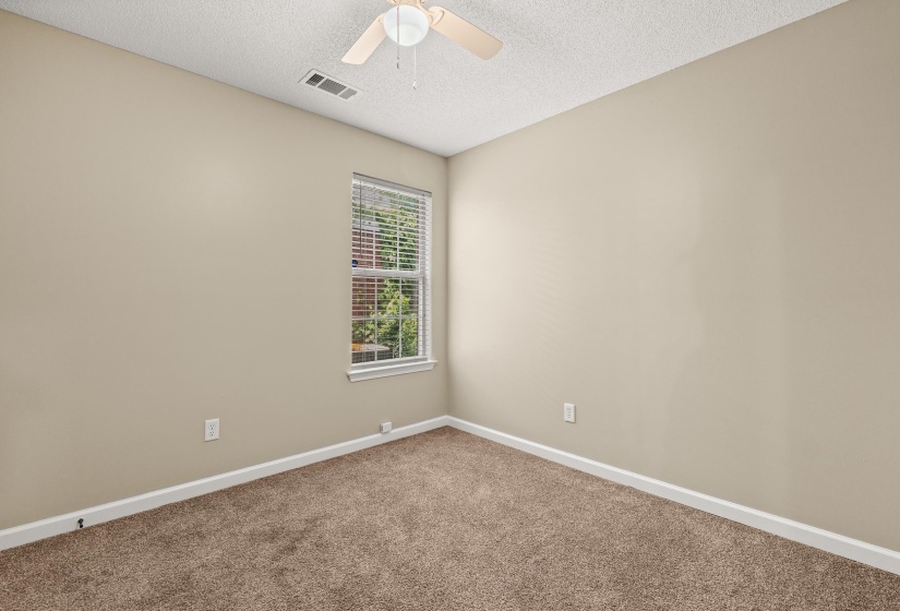 Room featuring neutral wall paint, textured ceiling, and brown carpeting