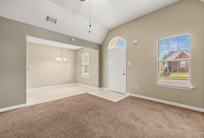 Entryway featuring a vaulted ceiling and an arched transom window above the front door