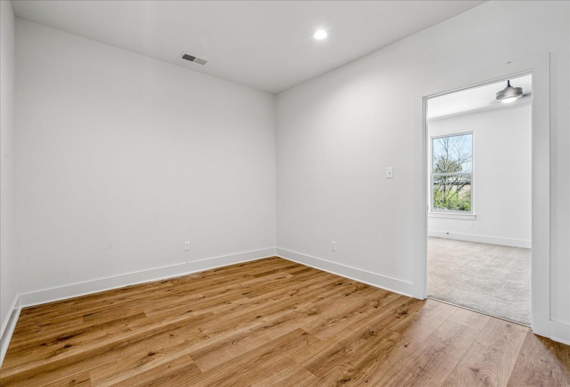 Spare room with light wood-style flooring and recessed lighting