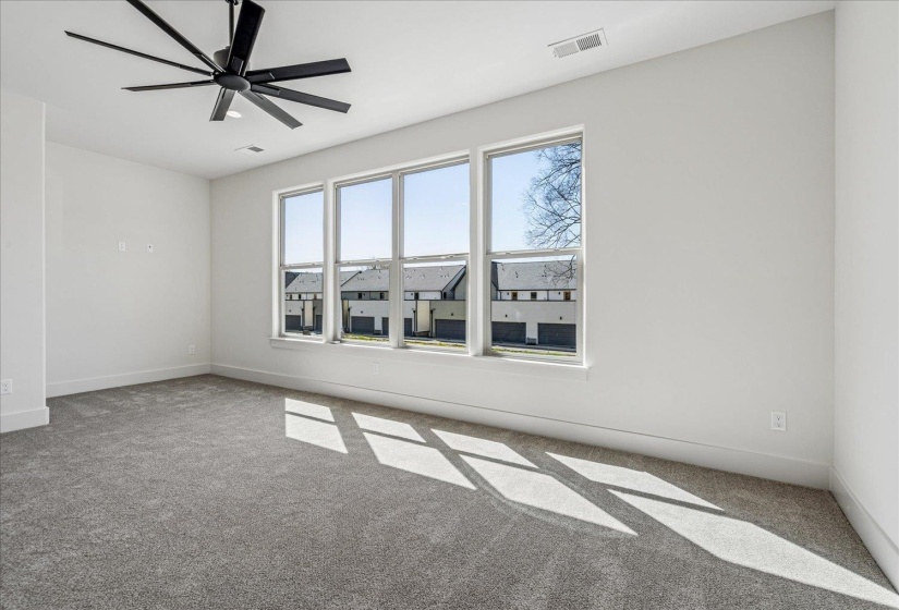 Spare room with light carpet and ceiling fan