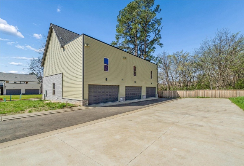 View of side of property featuring brick siding and driveway