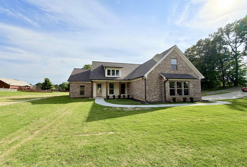Brick exterior with dark shingle roofing