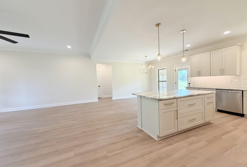 Open-concept kitchen and living area featuring light wood-finish flooring