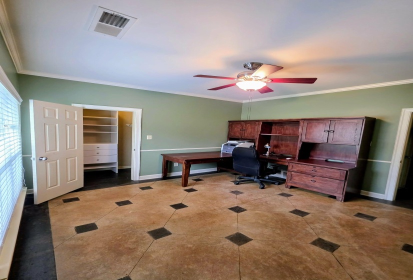 Room featuring decorative concrete flooring with dark diamond-shaped inlays and a dark border