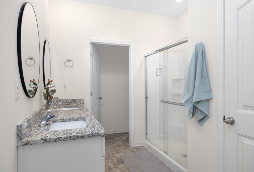 Double vanity with stone-finish countertop and undermount sinks