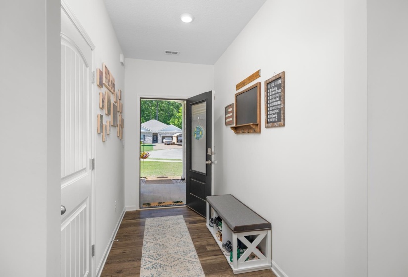 Entryway featuring wood-finish flooring, white walls, and a recessed ceiling light