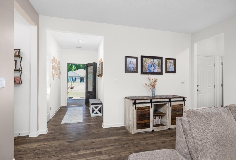 Spacious interior featuring wood-finish flooring and white baseboards
