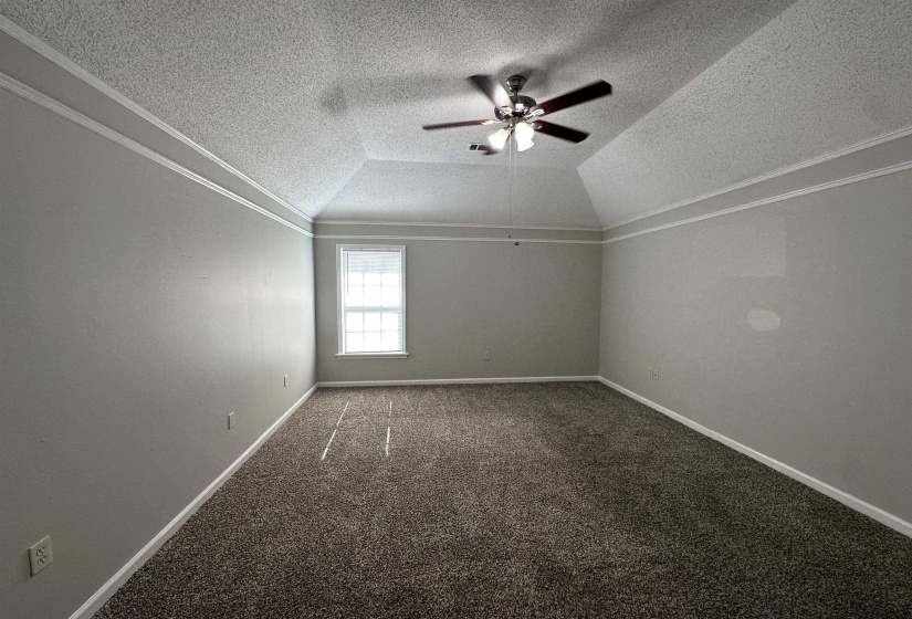 Bonus room featuring a textured ceiling, vaulted ceiling, a ceiling fan, and carpet flooring