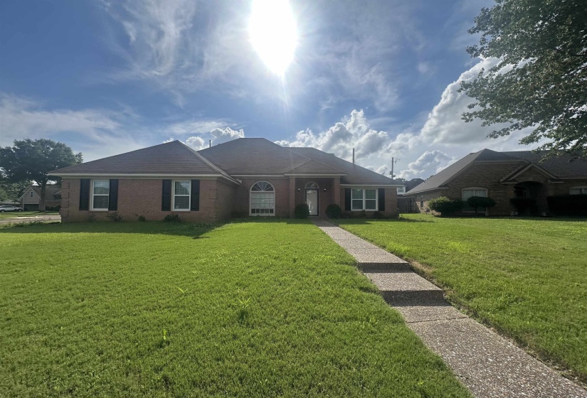 Ranch-style home with a front lawn and brick siding