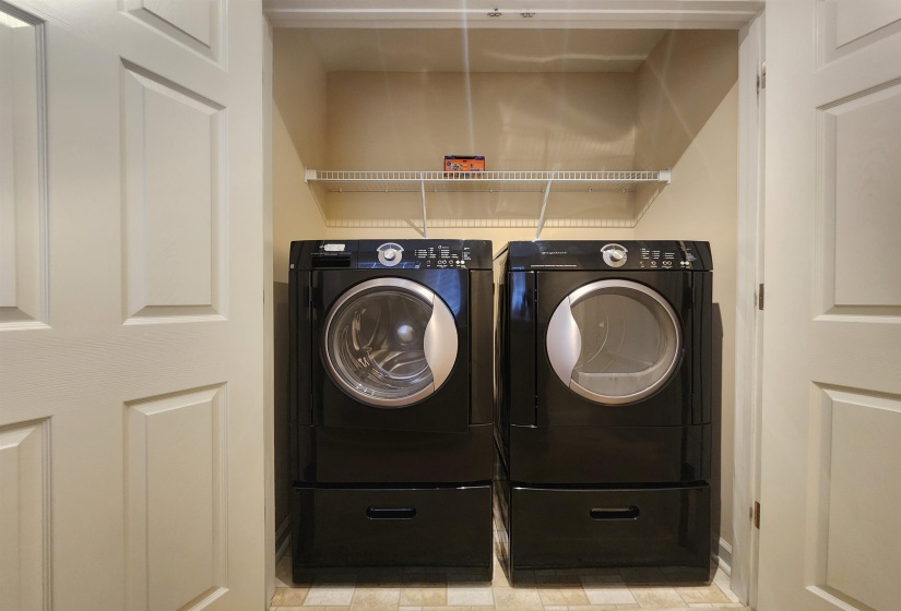 Clothes washing area featuring independent washer and dryer and laundry area