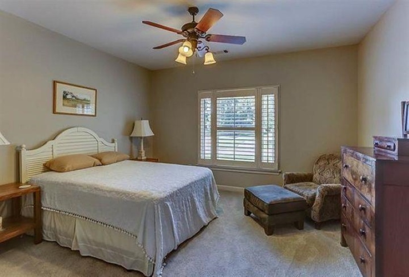 Bedroom featuring light carpet and ceiling fan