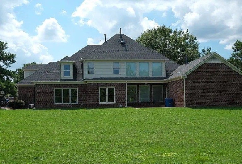 Rear view of house with a yard