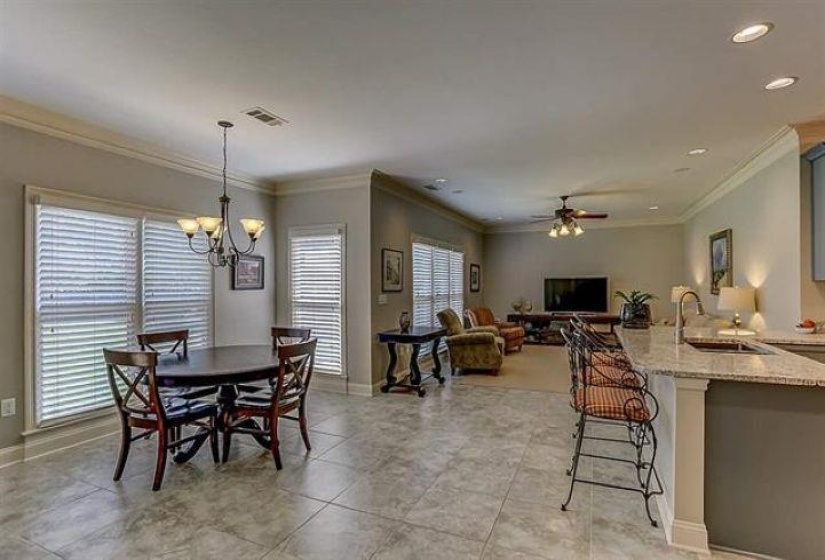 Dining room with recessed lighting, visible vents, ceiling fan with notable chandelier, and baseboards