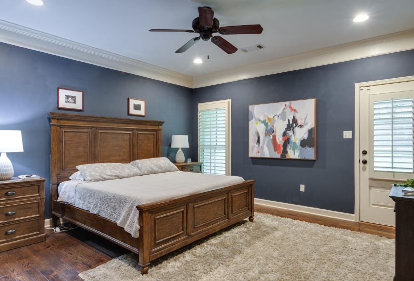 Spacious room featuring wood-finish flooring and a plush area rug