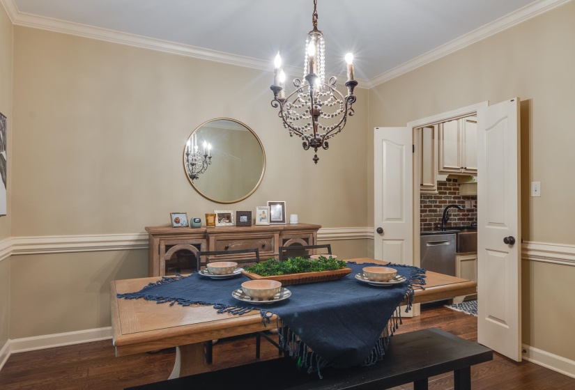 Formal dining area featuring hardwood flooring and extensive crown molding