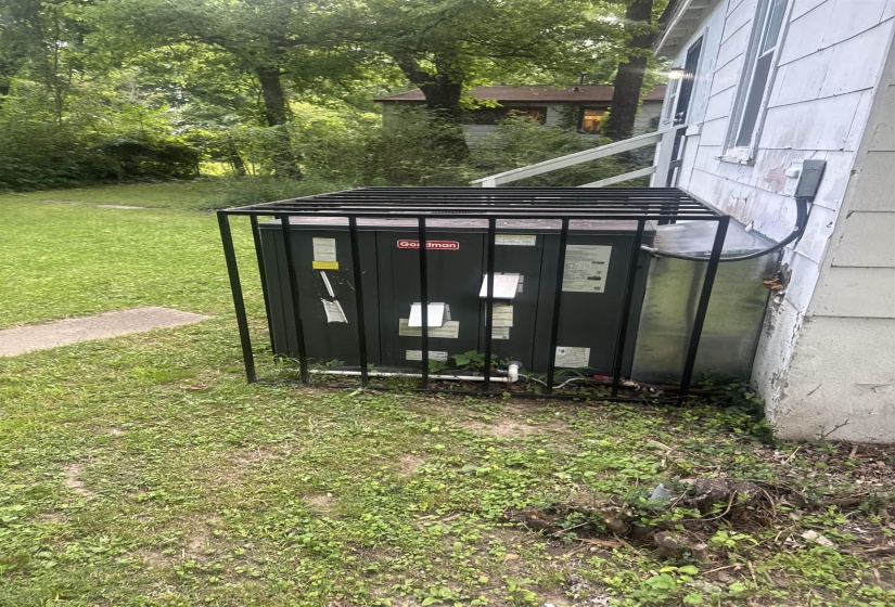 Exterior utility unit featuring a protective metal cage