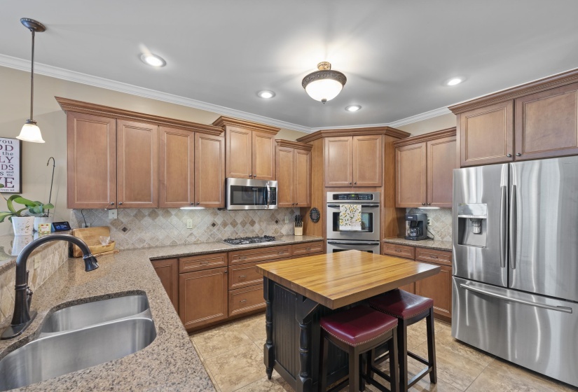 Wonderful kitchen equipped with a gas cooktop, double oven, microwave, abundant cabinetry, and generous counter space for cooking and entertaining.
