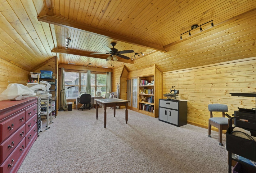 Incredible oversized bonus room with stunning wood-paneled walls and vaulted ceiling. Ideal for a game room, media room, hobby space, home office, or additional living area.