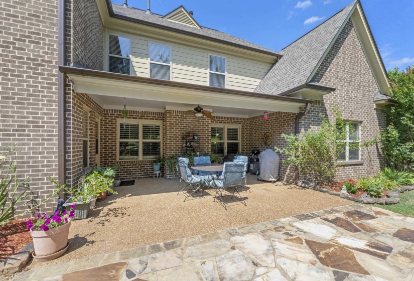 Enjoy outdoor living year-round on the large covered patio complete with ceiling fan, plenty of seating space, and views of the beautifully landscaped backyard.