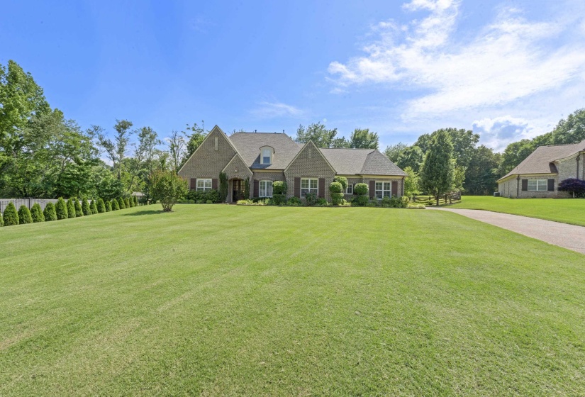 Beautiful brick home perfectly positioned on a sprawling, manicured lawn with mature landscaping and stunning curb appeal that immediately stands out.