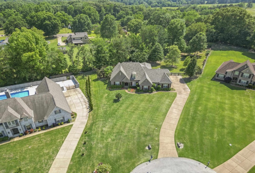 Stunning aerial view showcasing the home’s expansive lot, long driveway, mature trees, and beautiful setting with plenty of privacy and space to enjoy.