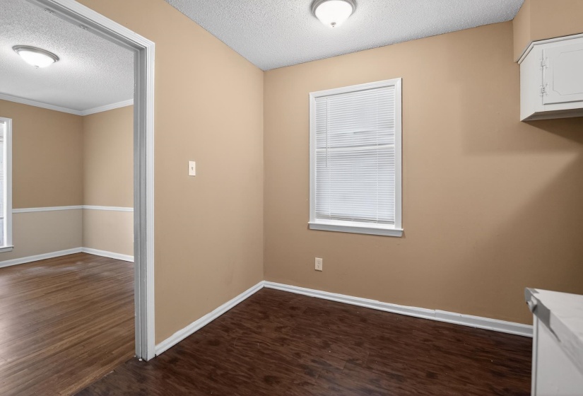 Interior space featuring wood-finish flooring, neutral wall tones, and white trim