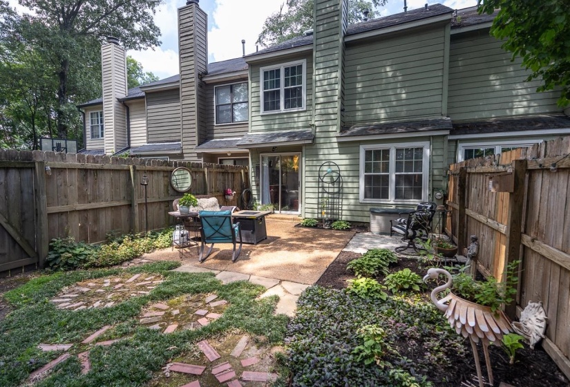 Back of property featuring a chimney, a patio, and a fenced backyard
