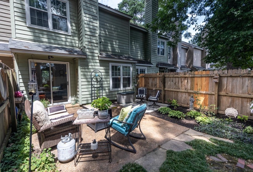 Fenced backyard with a patio