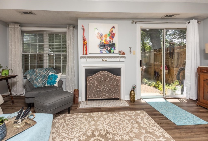Sitting room featuring wood finished floors and a fireplace with flush hearth