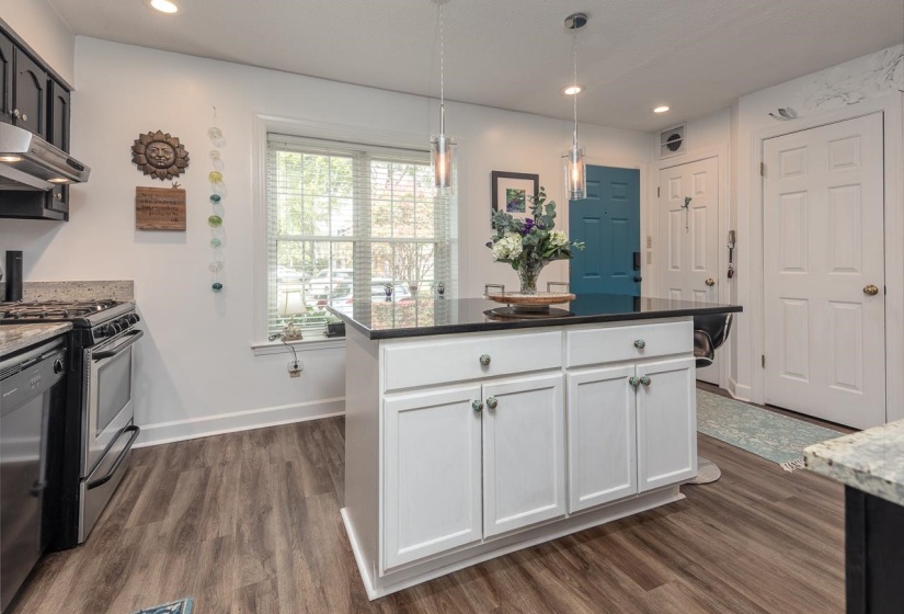 Kitchen featuring gas stove, dark wood-style floors, dishwasher, recessed lighting, and white cabinets