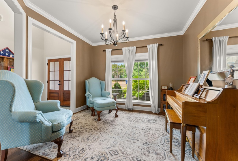 Interior room featuring crown molding, neutral wall color, and hardwood flooring